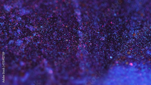 Wet glitter texture. Paint flow. Defocused neon blue pink color shimmering particles acrylic ink water wave motion abstract art background.