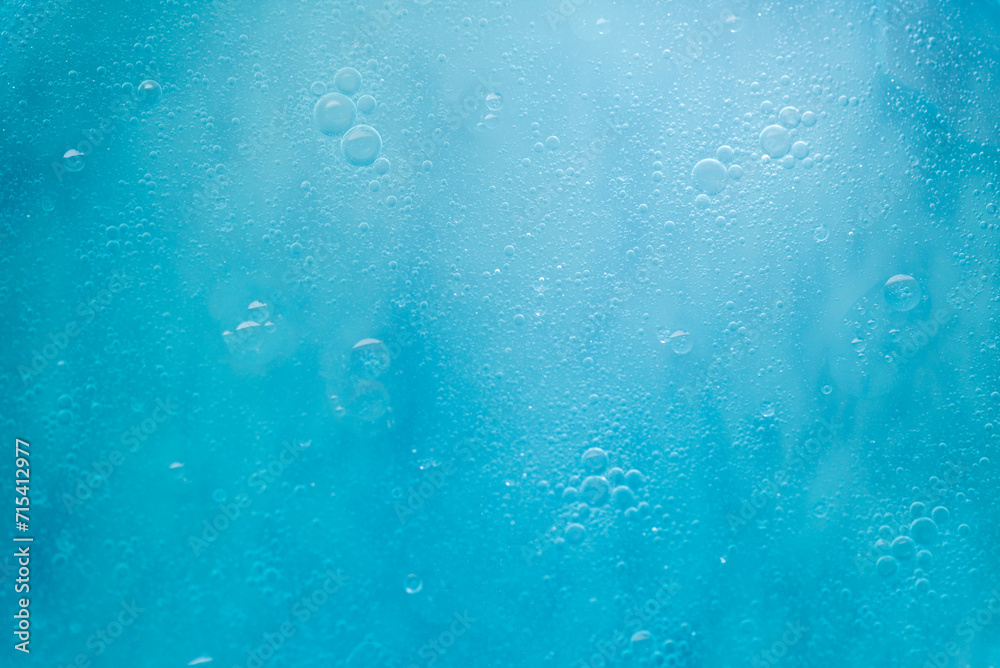 Air bubbles in the water background.Abstract oxygen bubbles in the sea.Water bubbles isolate on blue background.Sunlight underwater with bubbles rising to water surface in the ocean. Air bubbles in the water background.Abstract oxygen bubbles in the sea.Water bubbles isolate on blue background.Sunlight underwater with bubbles rising to water surface in the ocean.