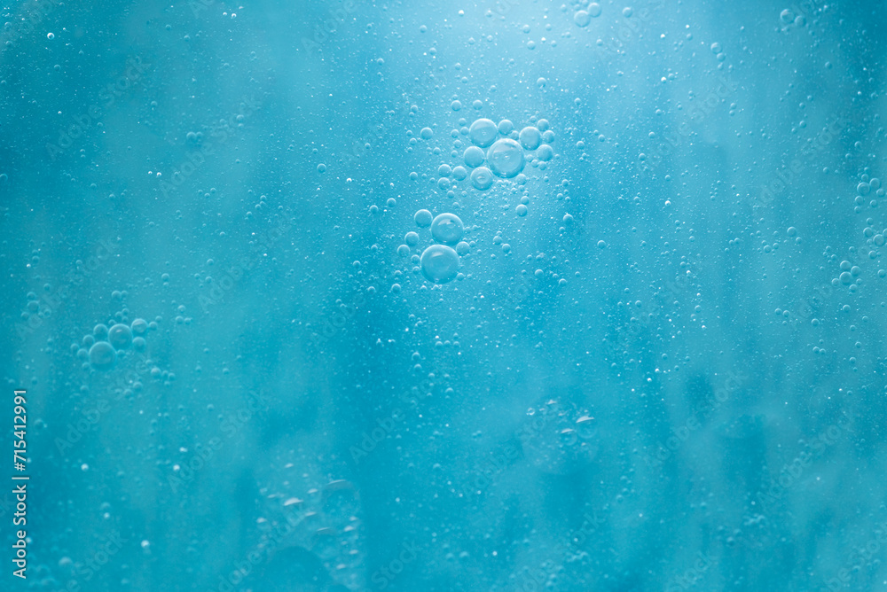 Air bubbles in the water background.Abstract oxygen bubbles in the sea.Water bubbles isolate on blue background.Sunlight underwater with bubbles rising to water surface in the ocean. Air bubbles in the water background.Abstract oxygen bubbles in the sea.Water bubbles isolate on blue background.Sunlight underwater with bubbles rising to water surface in the ocean.