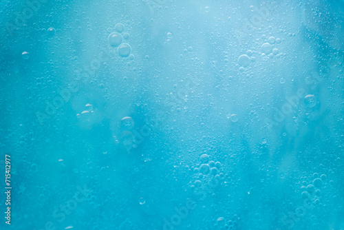 Air bubbles in the water background.Abstract oxygen bubbles in the sea.Water bubbles isolate on blue background.Sunlight underwater with bubbles rising to water surface in the ocean.
