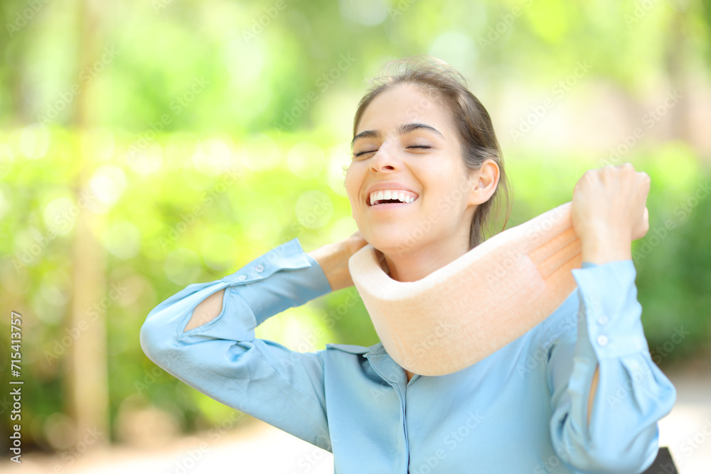 Happy woman taking off neck brace after convalescence