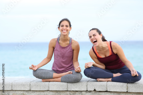 Two yogis laughing on the beach