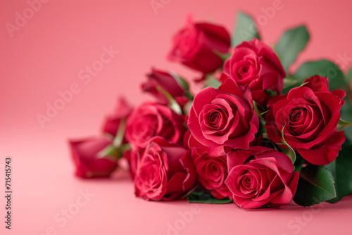 Bouquet of red roses laying against a soft pink background  symbolizing romance or Valentine s Day