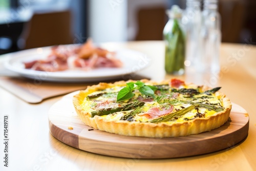 quiche with roasted asparagus on a wooden board