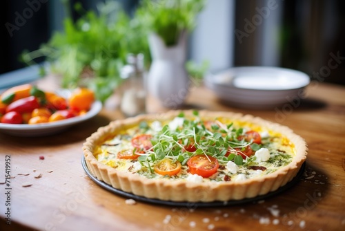 quiche with goat cheese and cherry tomatoes on top