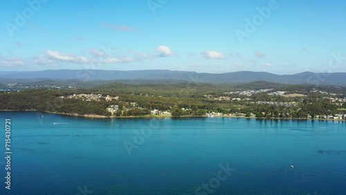 Fast aerial flying over Lake Macquaire from Bolton Point near council as 4k.
 photo