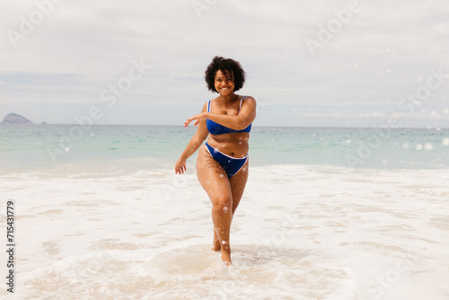 Woman in a bikini having fun during a summer vacation on a beach