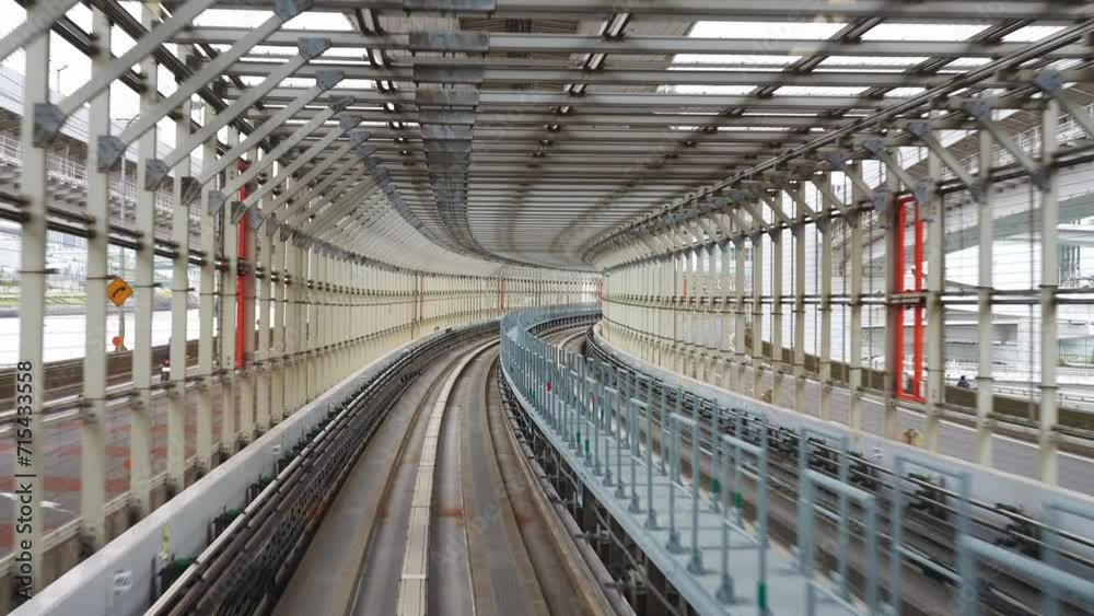 Tokyo Rainbow Bridge tunnel, Yurikamome monorail train on way to Odaiba island from city center. automated transit train in modern urban center. Tokyo Rainbow Bridge tunnel, Yurikamome monorail train on way to Odaiba island from city center. automated transit train in modern urban center.