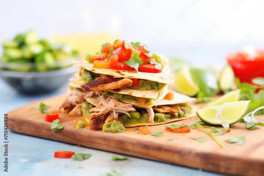 layered carnitas quesadilla slices with guacamole dip