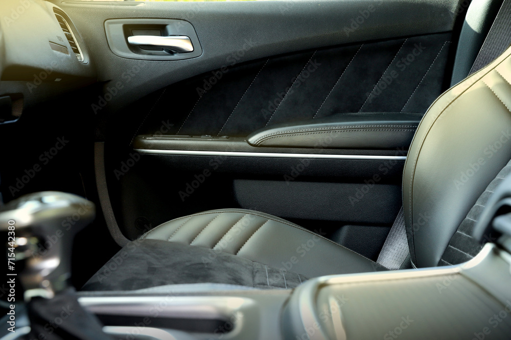 black interior of a modern car. Dashboard. Luxury leather steering wheel. Auto controls. Car doors inside. Car chairs and seats. Car sofa. Back and front row. Interior and door trim. High quality black interior of a modern car. Dashboard. Luxury leather steering wheel. Auto controls. Car doors inside. Car chairs and seats. Car sofa. Back and front row. Interior and door trim. High quality