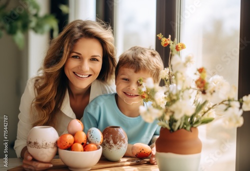 mom holding son in front of easter basket.