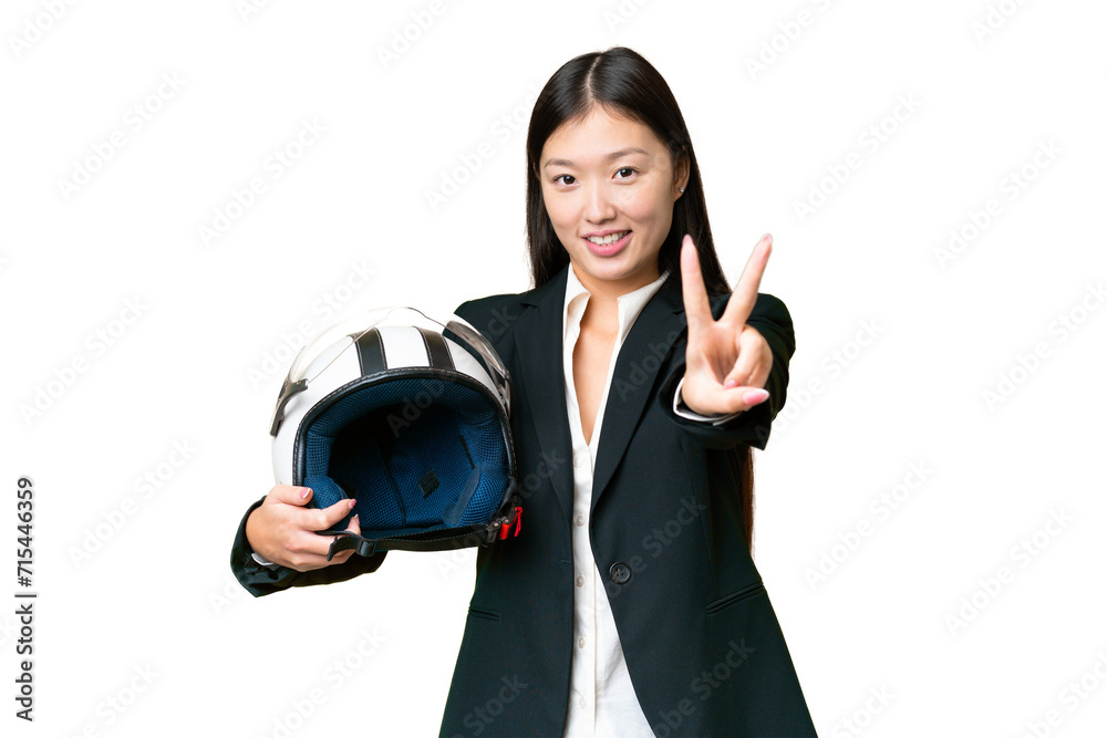 Young Asian woman with a motorcycle helmet over isolated chroma key background smiling and showing victory sign Young Asian woman with a motorcycle helmet over isolated chroma key background smiling and showing victory sign
