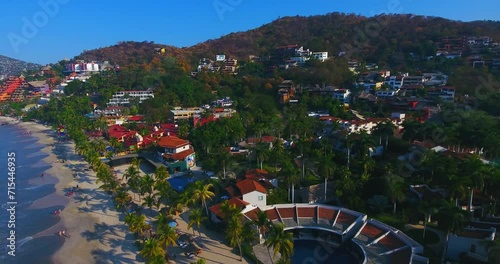 Looking down on the busy city over a stadium, houses, and businesses in the gorgeous town along the west coast of Mexico photo