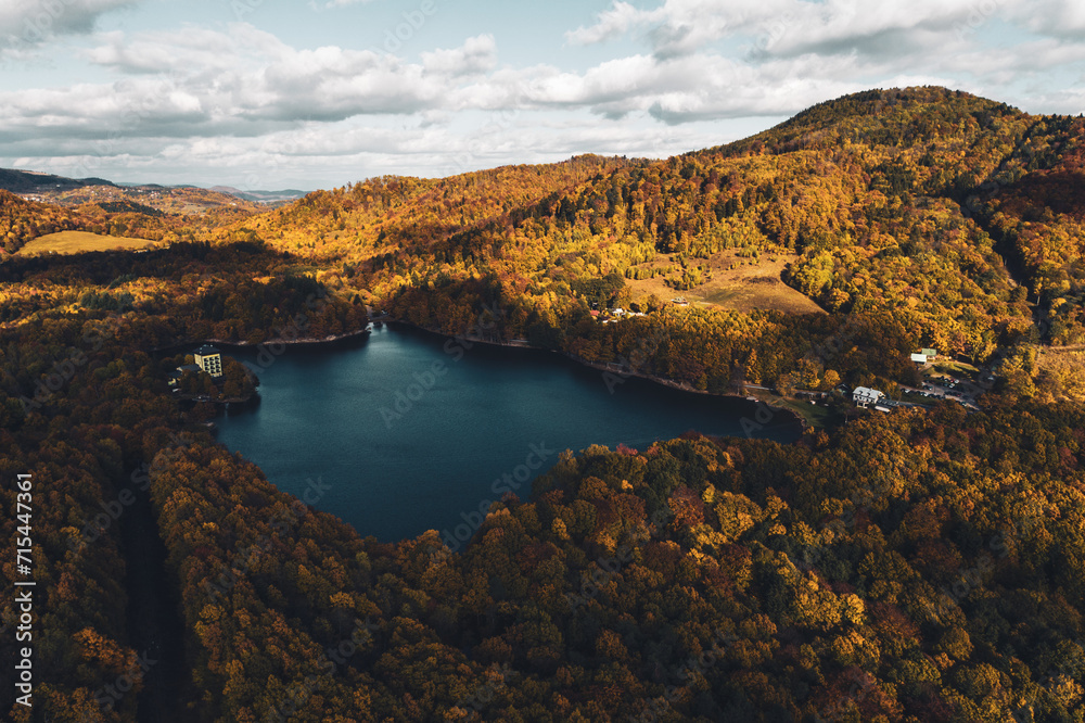 Top view of lake in the middle of autumn forest in Slovakia. Europe traveling concept.