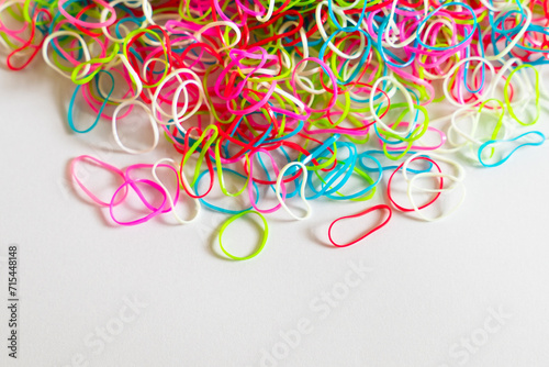 Colorful rubber bands or Mini Rainbow Purse Hair Bobbles, Colorful children's hair bands, flexible, made of para rubber, against white background.