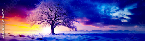 Snowy landscape with tree in the foreground and blue sky in the background.