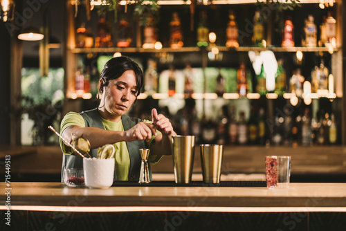 Bartender preparing cocktails in bar photo