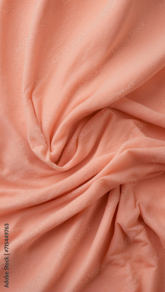 Soft focus texture of the silk fabric, peach color. Peach fabric background. Crumpled, soft rose color satin texture. Soft focus texture of the silk fabric, peach color. Peach fabric background. Crumpled, soft rose color satin texture.