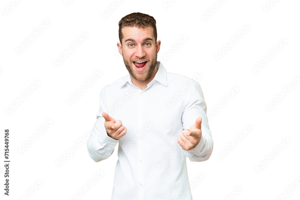 Young handsome blonde man over isolated chroma key background pointing to the front and smiling