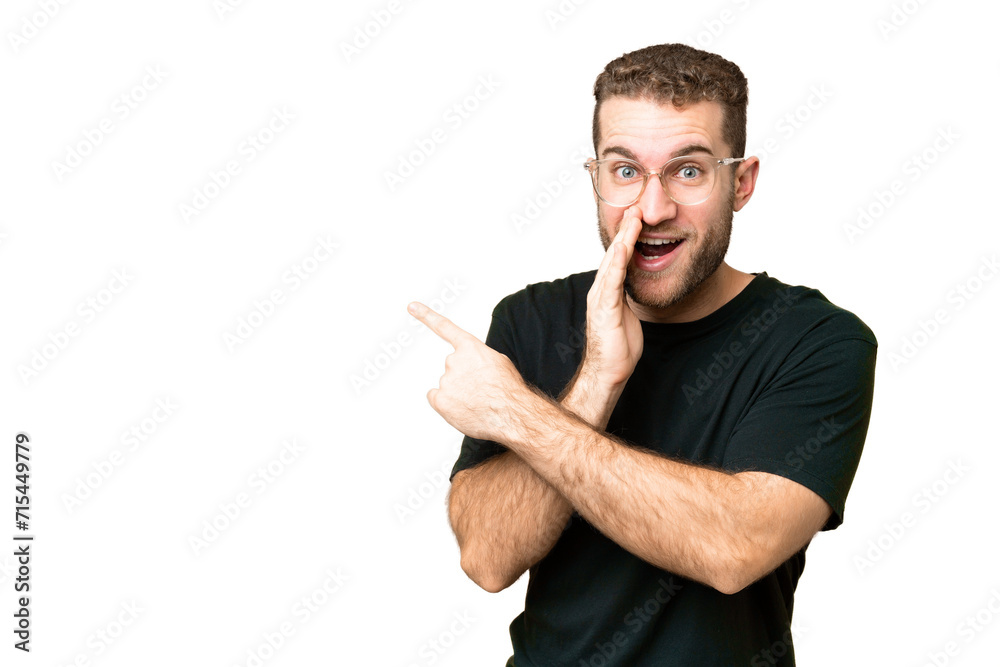 Young handsome blonde man over isolated chroma key background pointing to the side to present a product and whispering something Young handsome blonde man over isolated chroma key background pointing to the side to present a product and whispering something