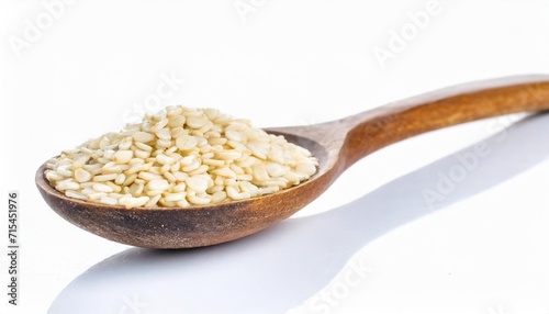 roast white sesame seeds in the wooden spoon isolated on white background