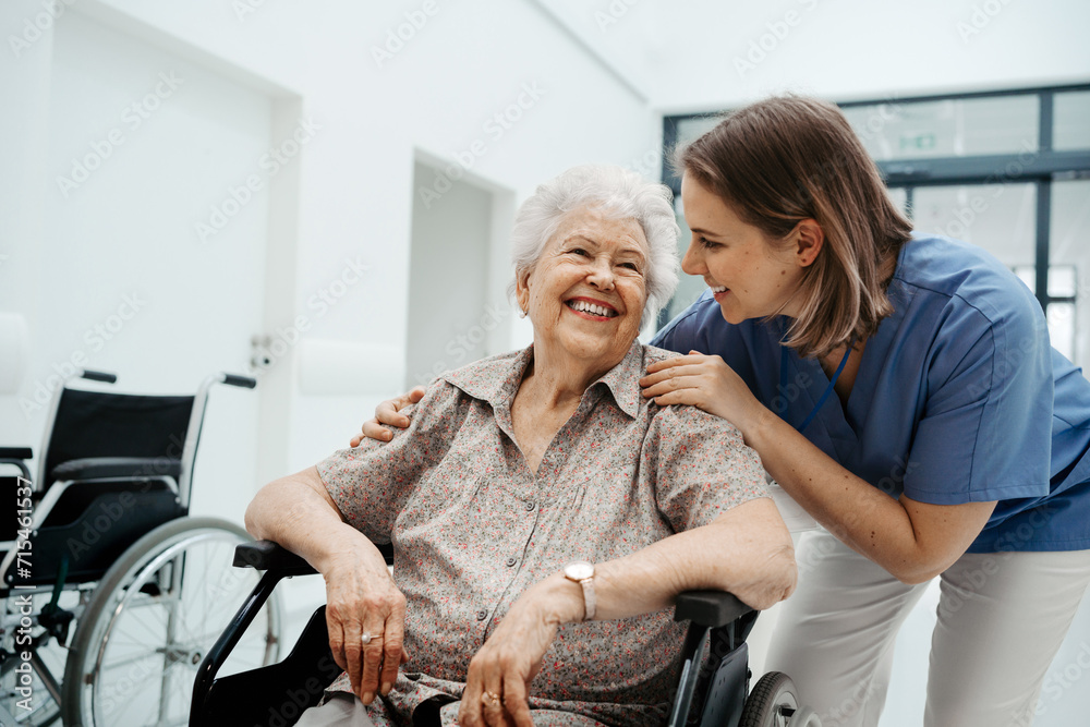 © Halfpoint - Portrait of nurse and senior patient talking in hospital corridor. Emotional support for elderly woman.