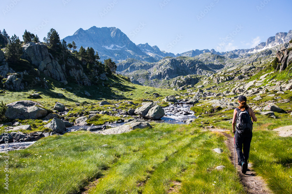 Young hiker girl summit to Ratera Peak in Aiguestortes and Sant Maurici National Park, Spain