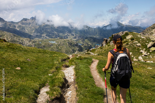 Young hiker girl summit to Ratera Peak in Aiguestortes and Sant Maurici National Park, Spain photo