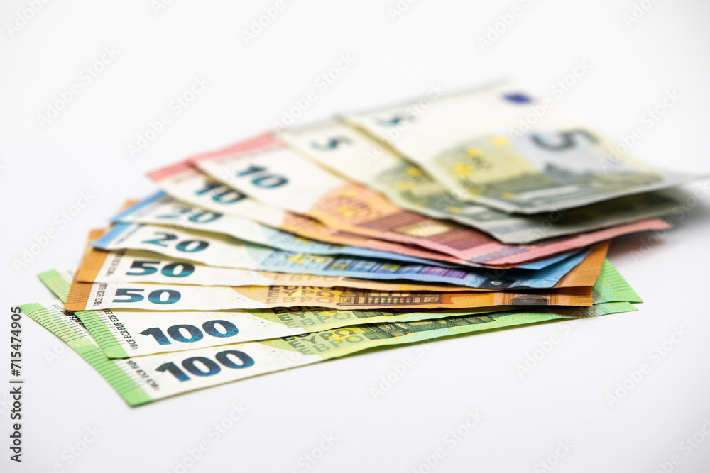 Pile of euro banknotes of 100, 50, 20, 10 and 5 euros. White background Pile of euro banknotes of 100, 50, 20, 10 and 5 euros. White background