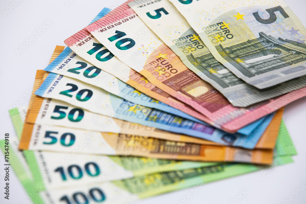 Pile of euro banknotes of 100, 50, 20, 10 and 5 euros. White background Pile of euro banknotes of 100, 50, 20, 10 and 5 euros. White background
