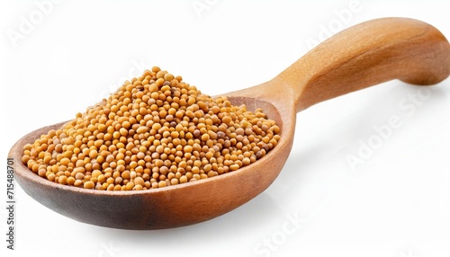 yellow mustard seeds in wooden spoon isolated on white photo