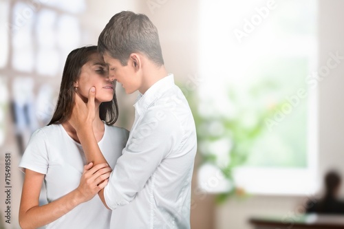Happy young Couple kissing in home