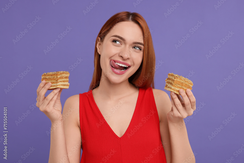 Young woman with pieces of tasty cake on purple background Young woman with pieces of tasty cake on purple background
