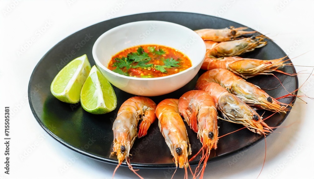 fresh shrimps in fish sauce with seafood dipping sauce on black plate isolated white background top view including clipping path