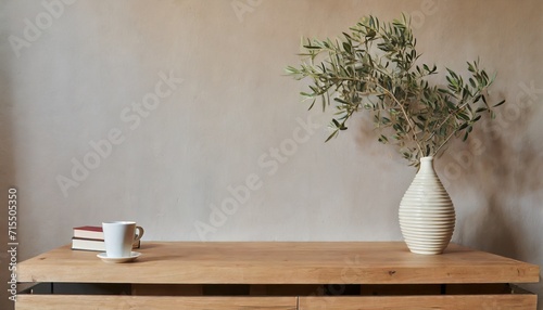 neutral mediterranean home design textured vase with olive tree branches cup of coffee books on wooden table living room still life empty wall copy space modern interior no people lateral view © Heaven