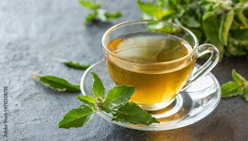 tulsi tea served in a cup with tulsi leaves tulsi has many benefits for body and mind