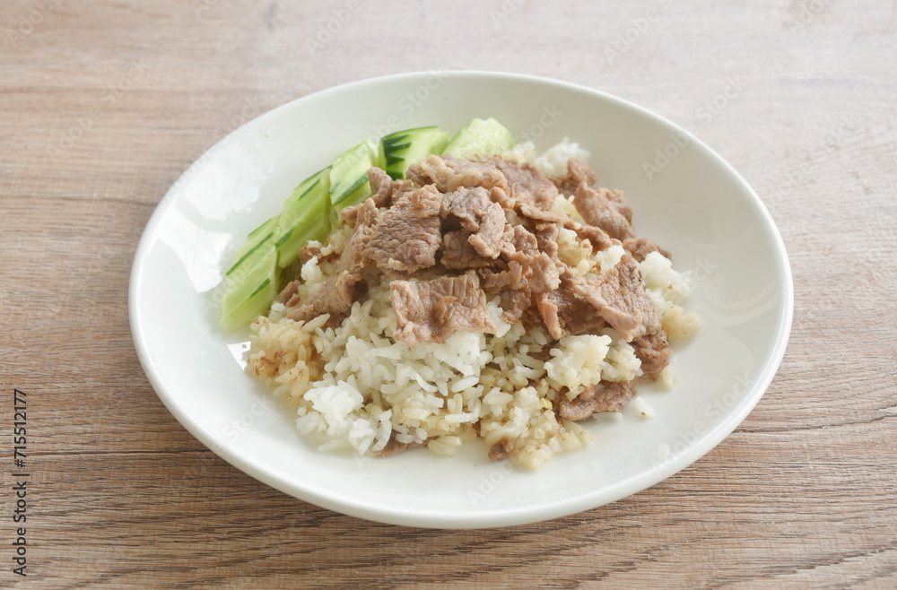 fried salty slice beef meat with garlic and pepper on rice in plate fried salty slice beef meat with garlic and pepper on rice in plate