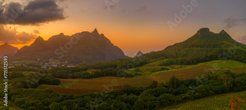 View of golden sunset behind Long Mountain and patchwork of green fields, Mauritius photo
