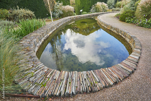A formal garden scene, with pond, in Devon, England