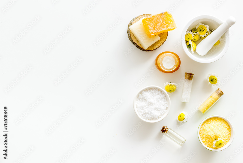 White and yellow chamomile flowers with herbal cosmetic beauty products White and yellow chamomile flowers with herbal cosmetic beauty products