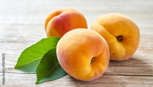 apricots isolated three whole falling apricot fruits with green leaves