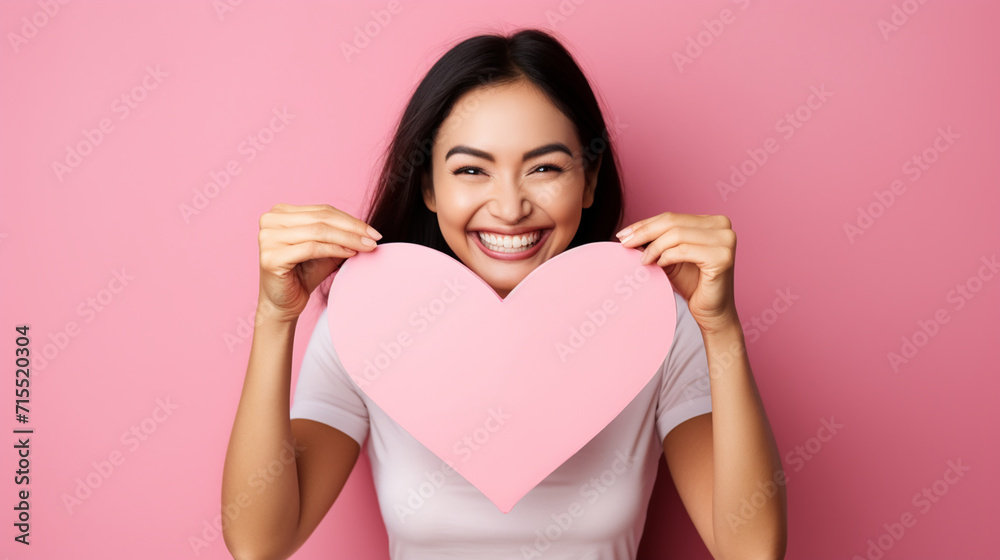 Attractive brunette young Asian woman feels happy and romantic shapes heart gesture expresses tender feelings Attractive brunette young Asian woman feels happy and romantic shapes heart gesture expresses tender feelings