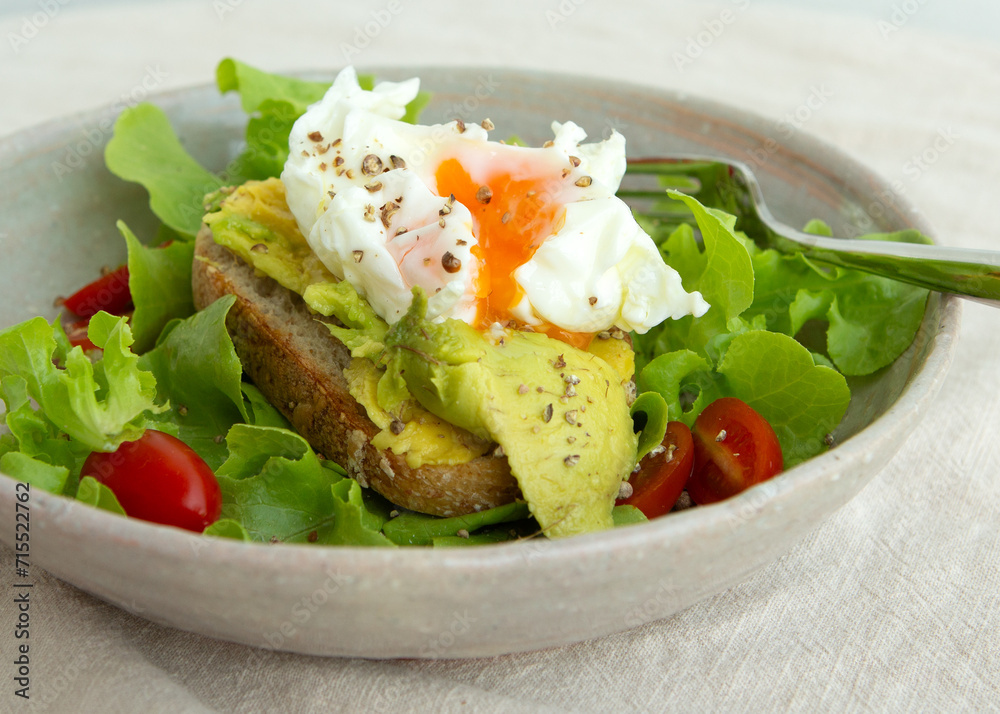 plate with avocado sandwich and poached egg on the table plate with avocado sandwich and poached egg on the table