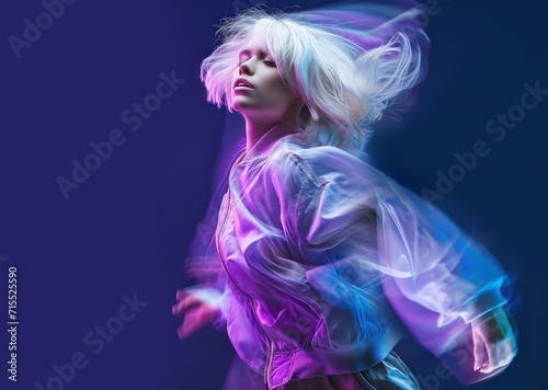 Fashion white short hair woman dancing over deep blue studio background  long exposure light effects