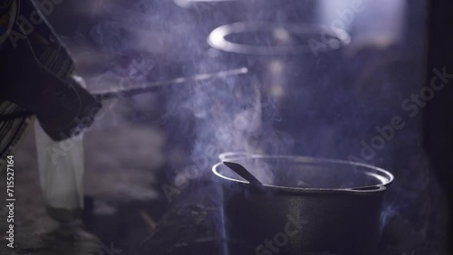 Cooking Traditional African Dish Over Fire At Night. Close up photo