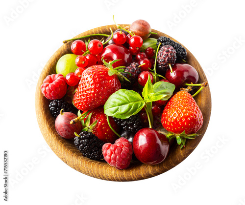 Different berries and fruits in a bowl. Mixed berries isolated in wooden bowl on white background.