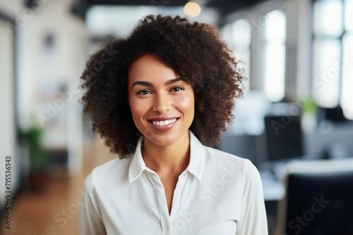 Happy confident african american businesswoman in office looking at camera