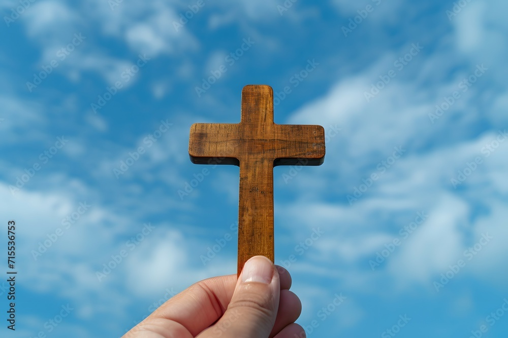 A wooden cross held against a blue sky symbolizing faith and reflection for Good Friday