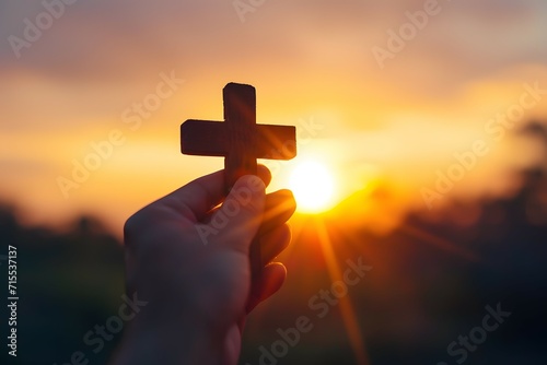 A wooden cross held against a blue sky symbolizing faith and reflection for Good Friday