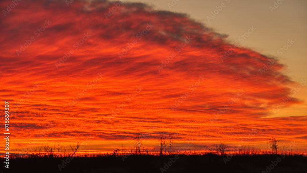 Dramatic colorful sunset on a cloudy sky during the cold season. Dramatic colorful sunset on a cloudy sky during the cold season.